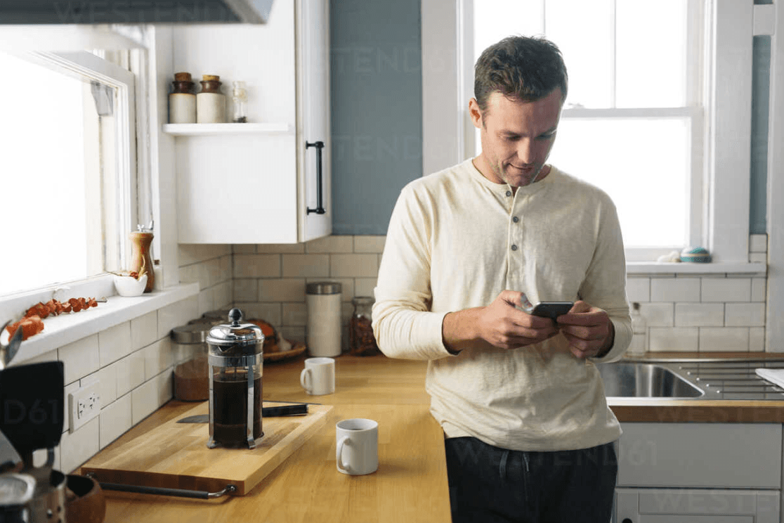 Man at home using Bumble on his phone