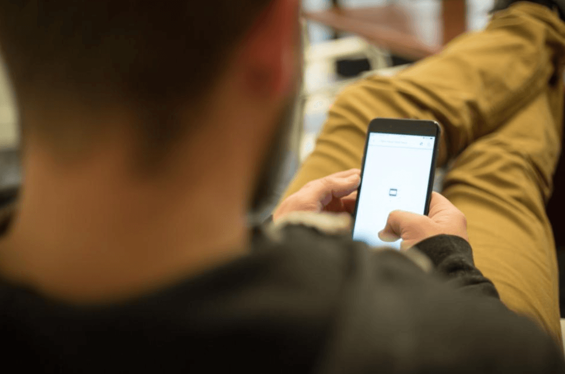 Man using Tinder on his phone